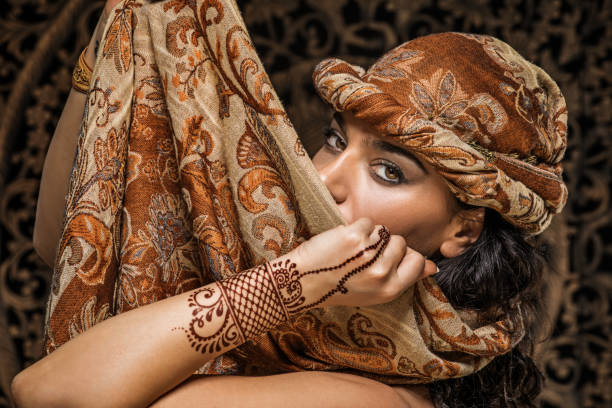 Beautiful Brunette Ethnic Woman wearing henna tattoo Beautiful Brunette Ethnic Woman wearing mehndi pattern henna tattoo and a headscarf MEHNDI stock pictures, royalty-free photos & images
