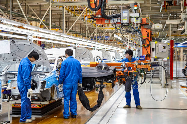 workers who install and install cars on the shanghai volkswagen factory assembly line are busy. - editorial land vehicle construction equipment built structure imagens e fotografias de stock
