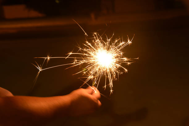 istock Child’s Hand Holding a Sparkler 1141364176