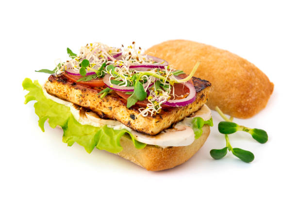 Opened vegan tofu burger with mushrooms and microgreens on white background with soft shadow Opened vegan tofu burger with mushrooms and microgreens on white background with soft shadow veggie burger photos stock pictures, royalty-free photos & images