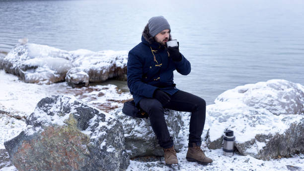 istock male hiker drinking hot tea from thermos 1141365764