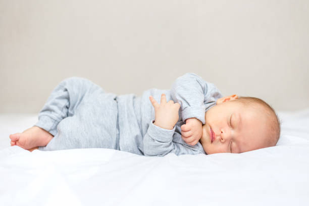 istock a newborn baby is sleeping on a blanket 1141366049