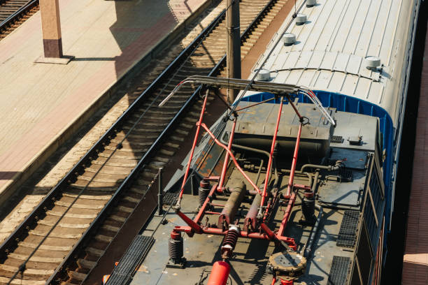 Electric train trolley pole. Railway electrification system. Overhead line wire over rail track. Power lines.