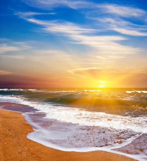 istock wavy  sea coast at the sunset 1141368798