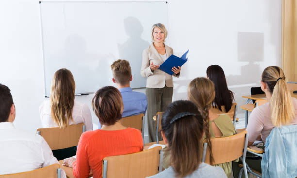 istock Female teacher lecturing to students 1141372777