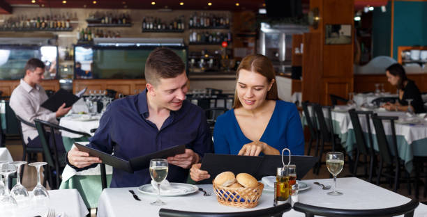 istock Couple and reading menu in restaurant 1141373277