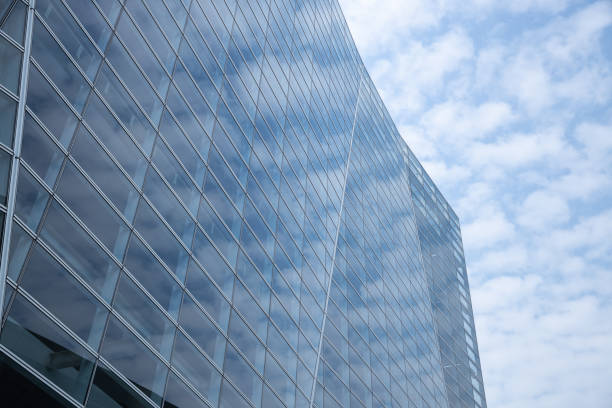 istock Cloud and sky reflected in the blue glass windows of building. 1141375753