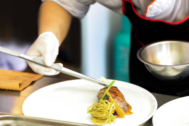 istock Chef preparing food, meal, in the kitchen, chef cooking, Chef decorating dish 1141376837