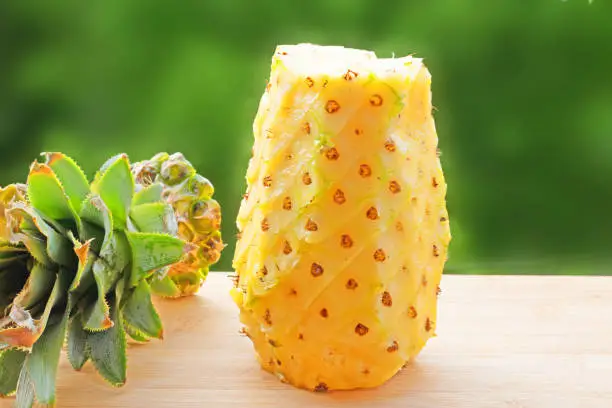 Raw pineapple with green background-image