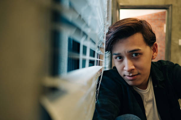 istock Young man looking at camera near the window 1141380524