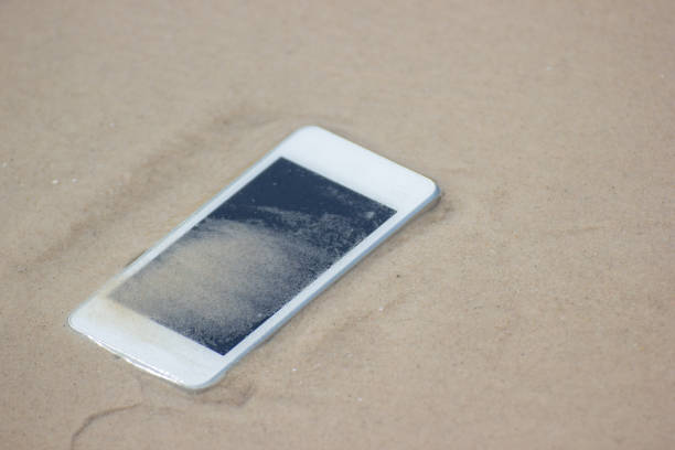 istock White Mobile phone floated to the sea at the beach. 1141380647