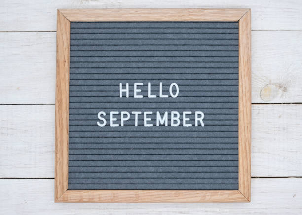 English text Hello September on a letter Board in white letters on a gray background