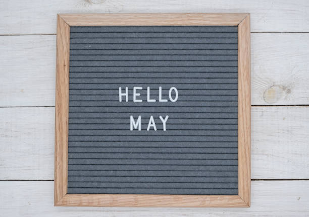 istock English text Hello May on a letter Board in white letters on a gray background 1141381332