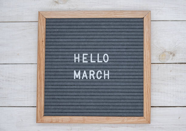 istock English text Hello March on a letter Board in white letters on a gray background 1141381337