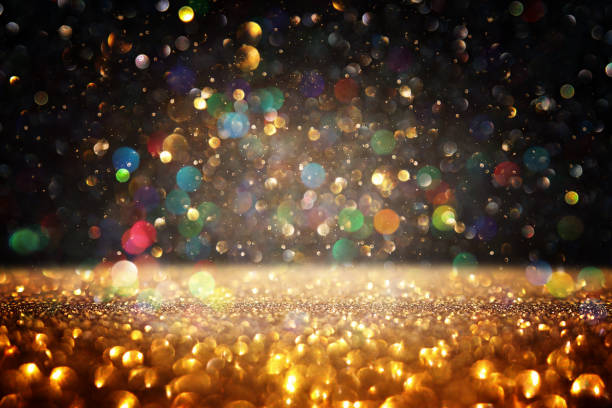 istock glitter vintage lights background. black and gold. de-focused 1141382307