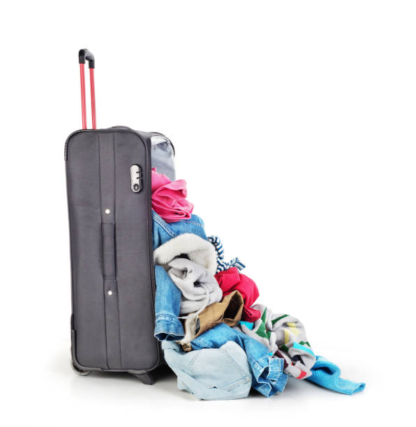 istock Open suitcase with clothing isolated on a white 1141385255