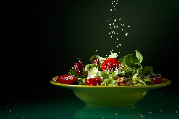 istock Green salad with cherry tomatoes, walnuts and sesame. 1141386232