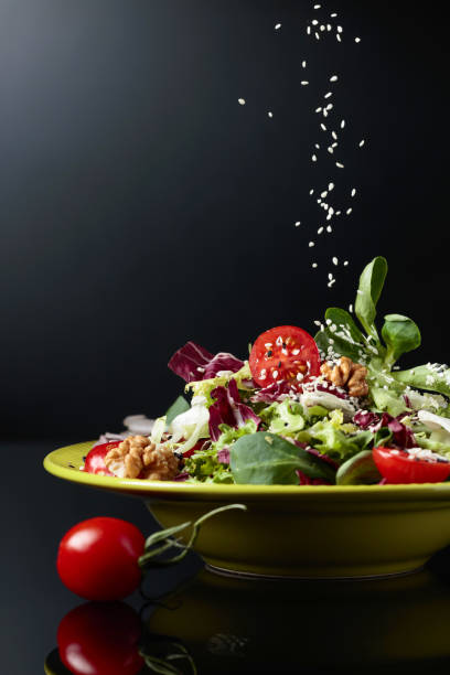 istock Green salad with cherry tomatoes,  sesame, walnuts and vegetable oil. 1141386242