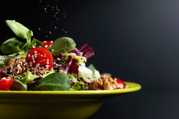 istock Green salad with cherry tomatoes,  sesame, walnuts and vegetable oil. 1141386244