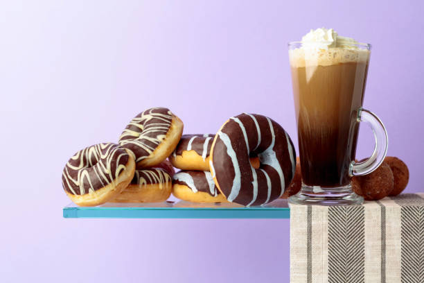 istock Chocolate donuts and coffee cocktail with cream. 1141386276