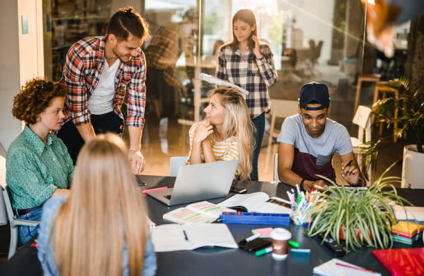istock College students talking while learning in team for upcoming exams in a library. 1141388730