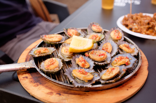 A plate of grilled limpets ready to eat in the Azores