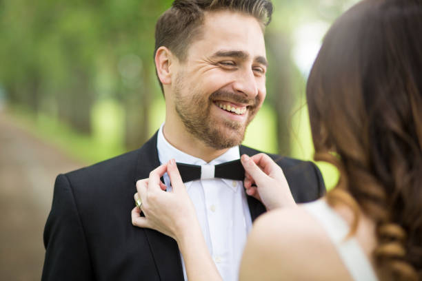 istock Fixing groom's bowtie at a wedding 1141391065