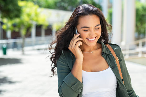 istock Latin smiling woman talking on phone 1141392401