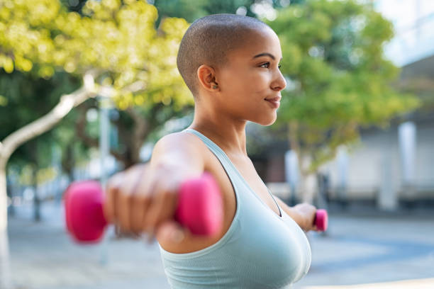 istock Curvy black woman using dumbbell 1141394301