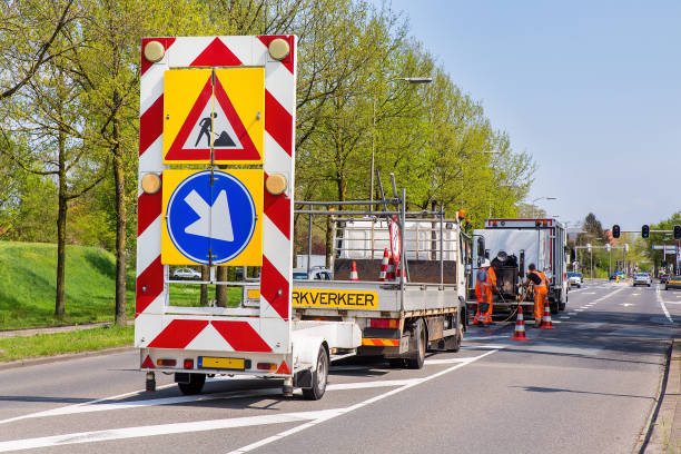 istock Road works with trucks and traffic signs 1141394488
