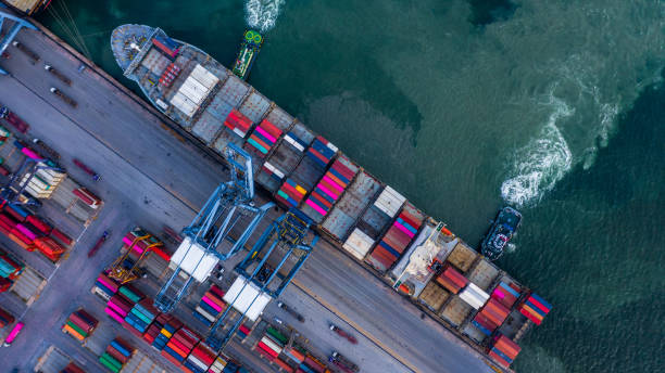 istock Aerial top view container cargo ship unloading in import export business logistic and transportation of international by container cargo ship in the open sea. 1141398755