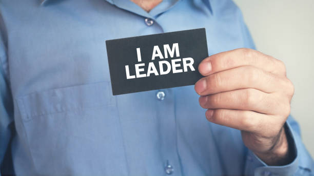 istock Man holding text I Am Leader on business card. 1141399886