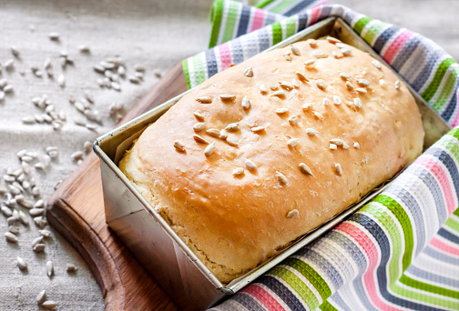 White yeast bread with sunflower seeds baked in tin baking dish