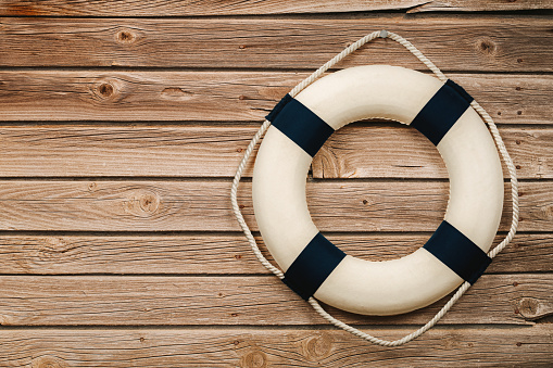 Close up of life buoy on the wooden background with copy space