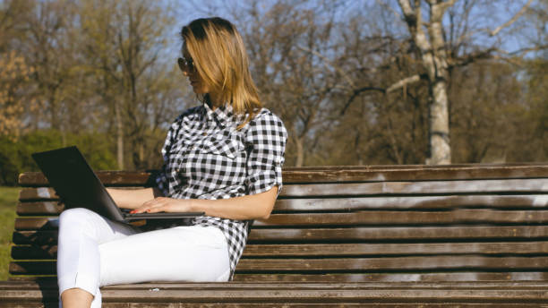istock Businesswoman on bench working 1141401349