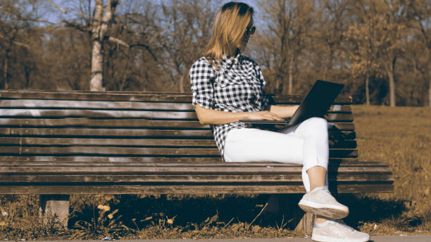 istock Businesswoman on bench working 1141401475
