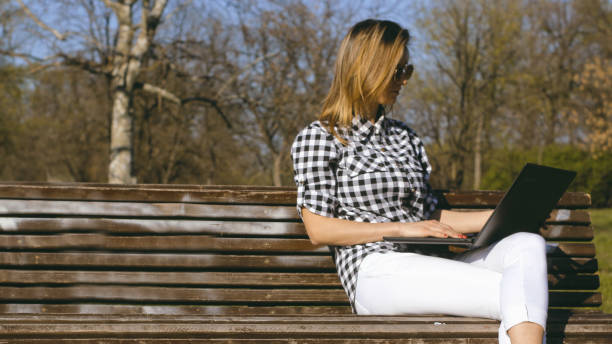 istock Businesswoman on bench working 1141401497