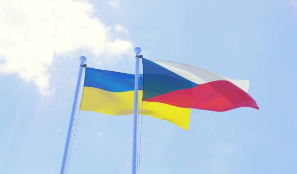 istock Czech Republic and Ukraine, two flags waving against blue sky 1141402774