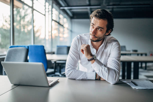 istock Charming businessman sitting in office 1141402940