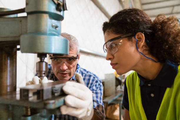 istock Engineer teaching female trainee in factory 1141403016