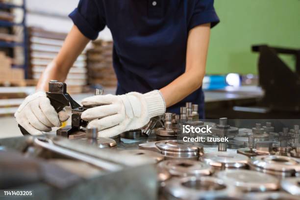 Female Trainee Using Manufacturing Machinery Stock Photo - Download Image Now - 30-34 Years, Adult, Adults Only