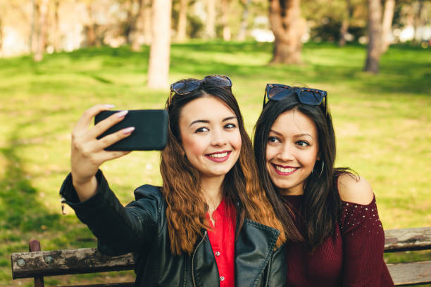 istock Two beautiful sisters taking selfies together 1141404466