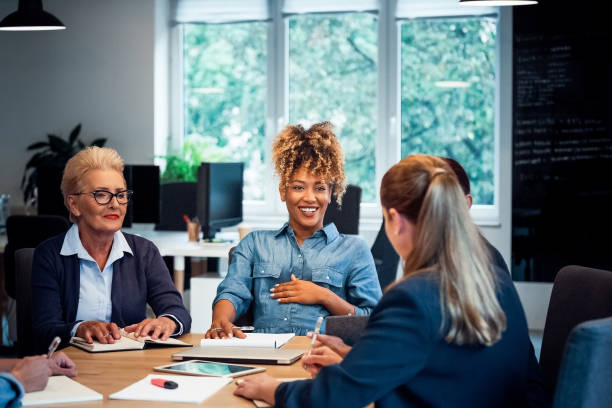 istock Smiling business colleagues communicating at desk 1141404657
