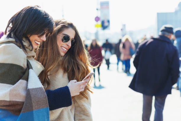 istock Smiling travelers using mobile phone 1141404774