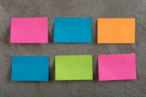 istock Many colorful sticky note on grey cement background. Copy space 1141404861