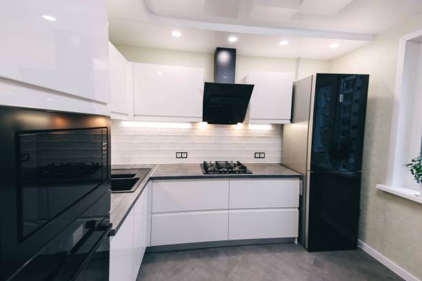 istock interior of a modern compact white kitchen with gas stove, oven, refrigerator. built-in furniture household appliances 1141404902