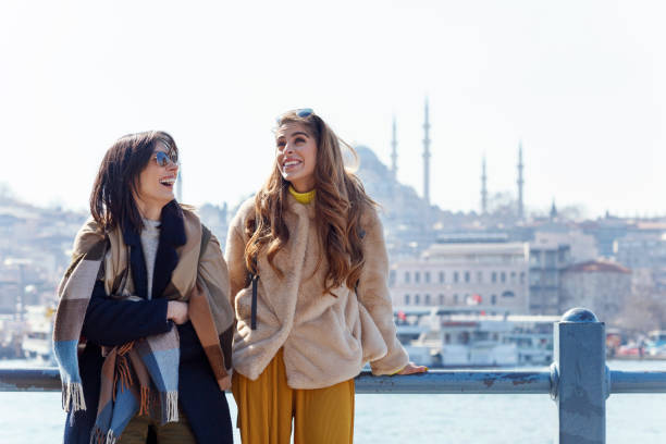 Two young women friends sharing happy time together