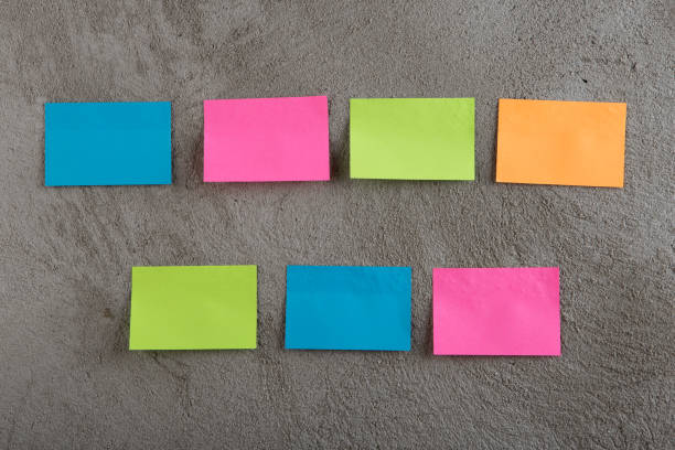 istock Many colorful sticky note on grey cement background. Copy space 1141405823
