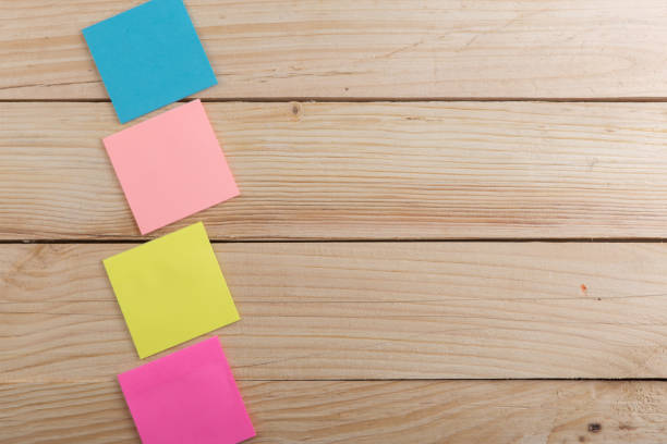 istock Many colorful sticky note on wooden desk. Copy space 1141405895