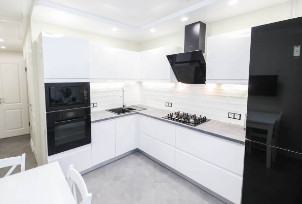 istock interior of a modern compact white kitchen with gas stove, oven, refrigerator. built-in furniture household appliances 1141405921